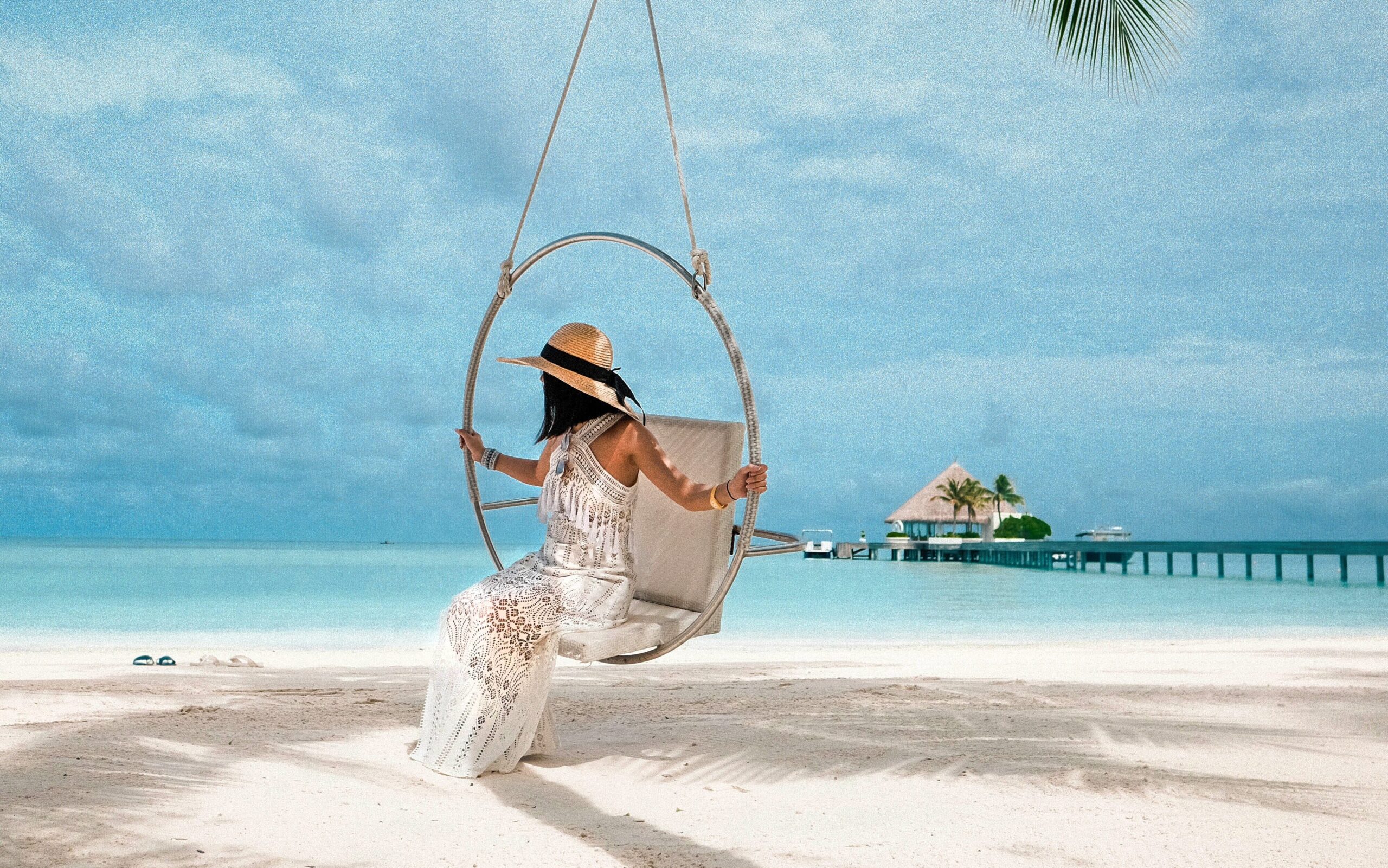 A woman on a hammock in a beautiful island of Maldives